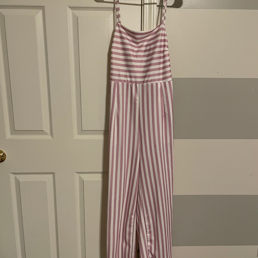 Pink and white pant romper with unique tie back.